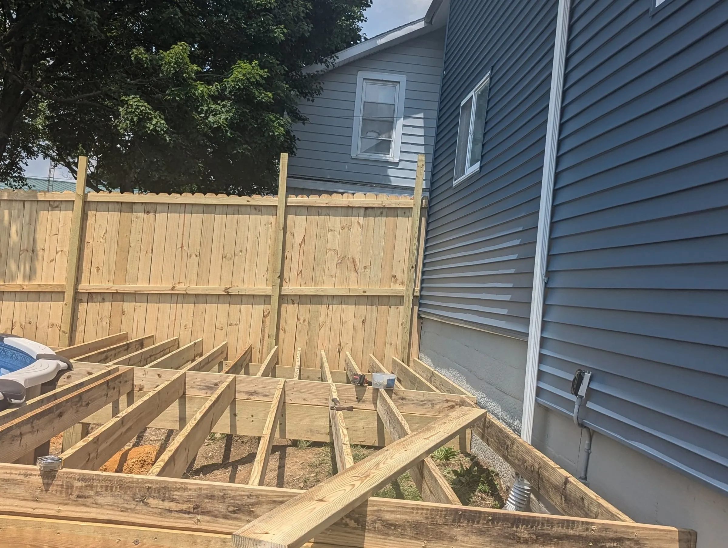 Deck joists running along the house toward the fence